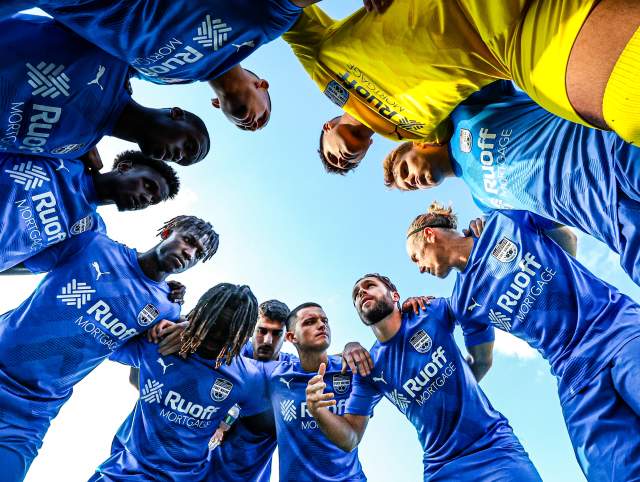 fort wayne fc mens soccer team in a huddle during a game