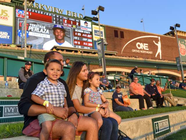 family enjoying a tincaps baseball game at sunset