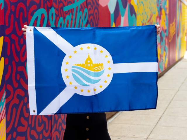 Holding up the new 2025 Allen County, Indiana flag in downtown Fort Wayne, Indiana