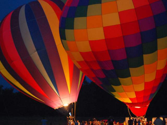 Hot air balloons taking off at the Allen County Fair.