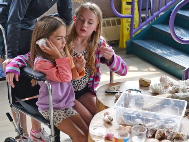 Girls in a wheelchair experimenting at Science Central.