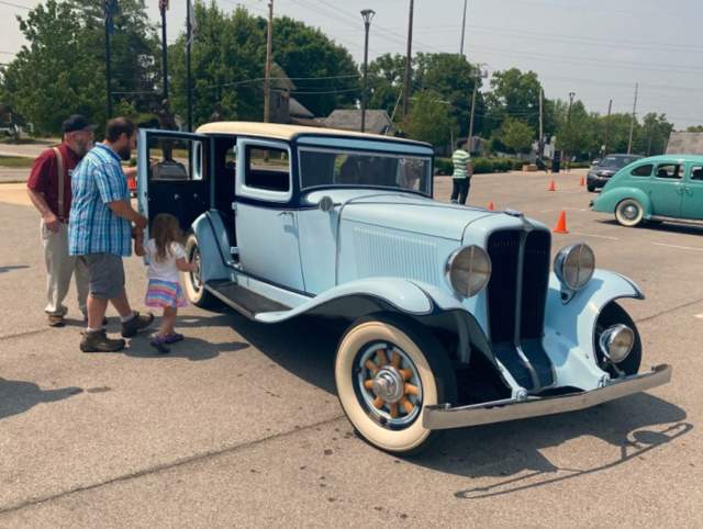 Families getting to ride in classic cars. Auburn, Cord, and Model T.