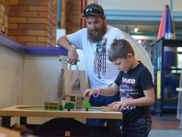 Father and son at an exhibit together.