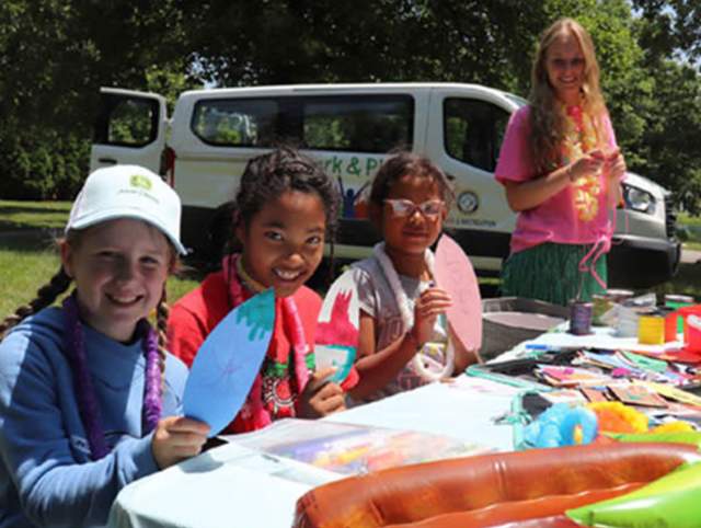 Picture of three kids creating art in park