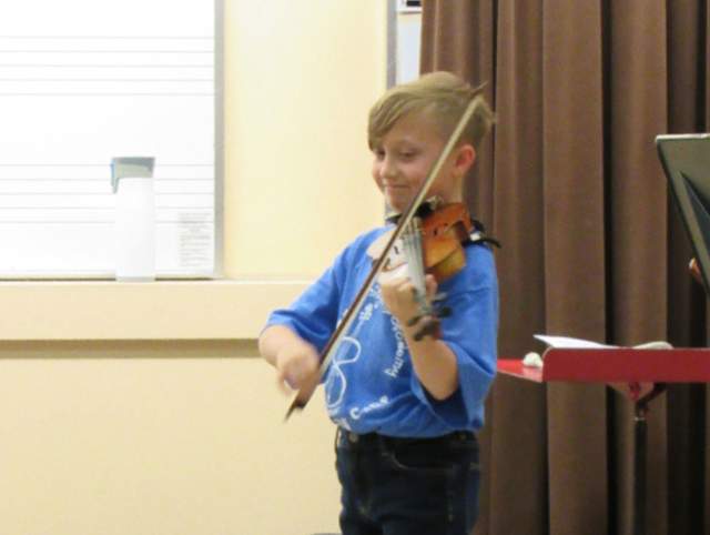 young child playing violin