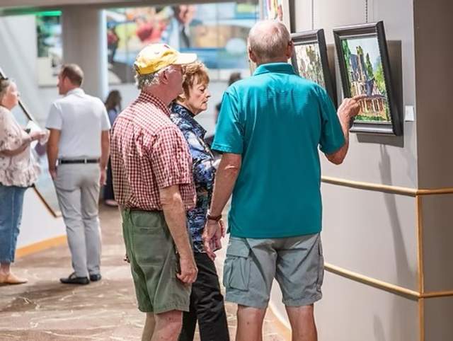 Group of people admiring a painting at the Clark Gallery