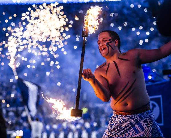 Fire dancer performer at a BYU football game, similar entertainment featured at First Down Provo