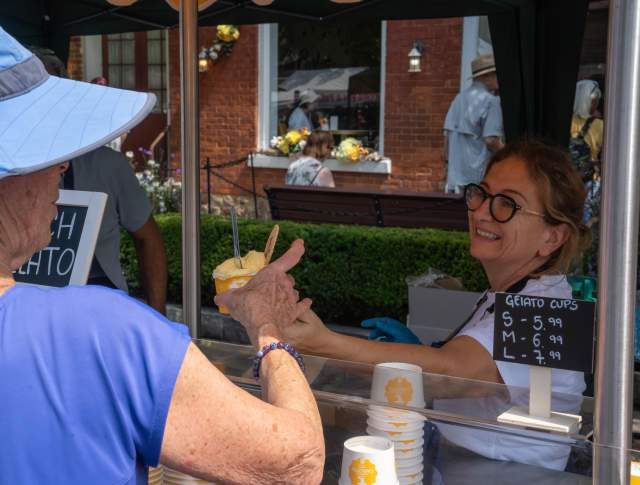 Woman serving frozen dessert to a customer