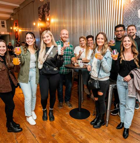 Group of friends raising their glasses to cheers