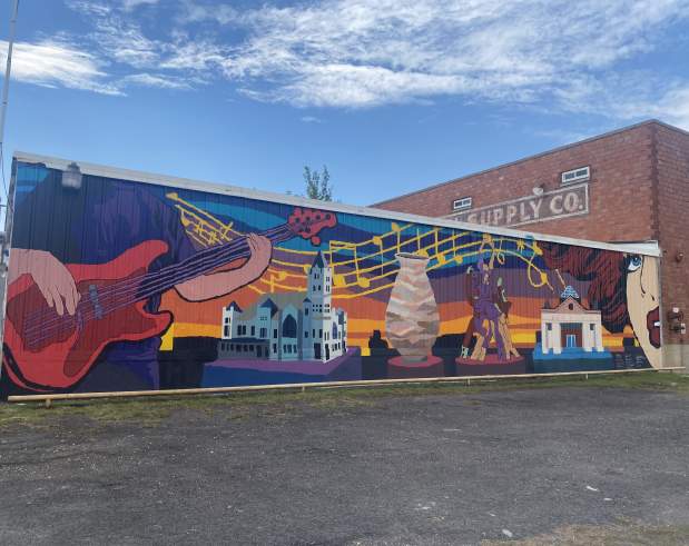 a mural of the arts in Beaumont, including music, books, museums, pottery, sculptures, and performance art