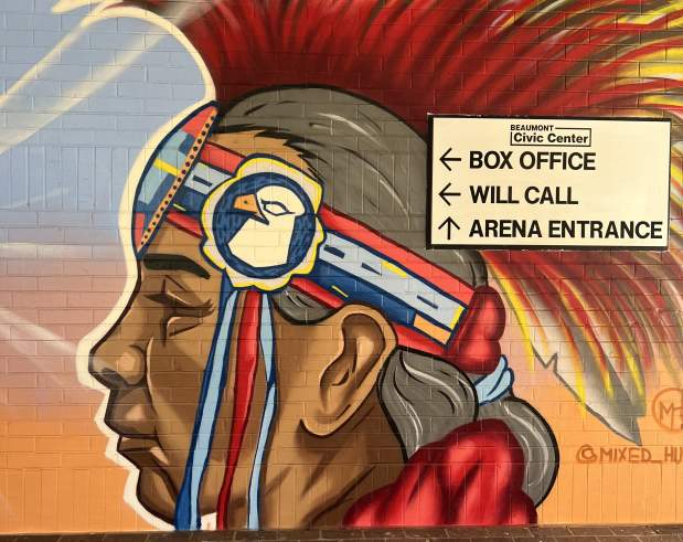 a mural displaying indigenous people in a traditional way