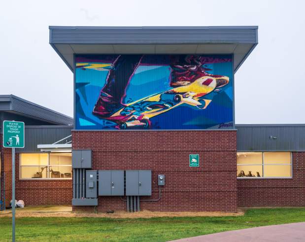 a mural displaying two feet on a skateboard