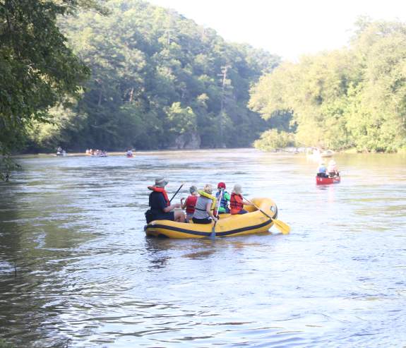 A group in a yellow raft are rafting on the Chattahoochee River in Sandy Springs, Georgia