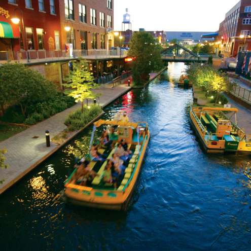 Group riding water taxi along the Bricktown Canal