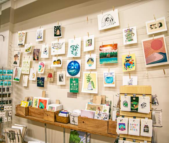 Display of wall art and prints at Gather Handmade Shoppe