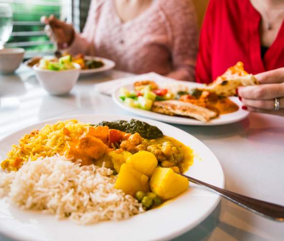 Several plates filled with authentic Indian cuisine from Taste of India