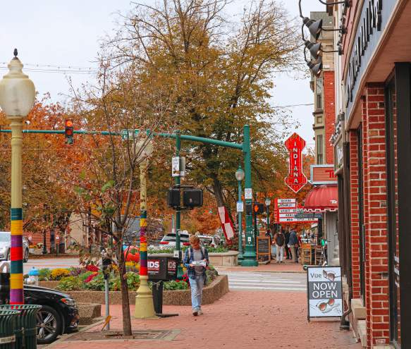 A student reading the IDS as they walk down the street on The Square