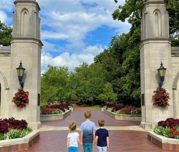 Three small kids holding hands at Sample Gates