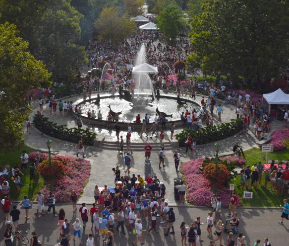 A crowd of people around Showalter Fountain during a First Thursdays event