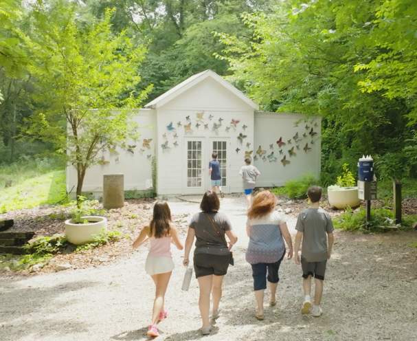 A group of people walking into the Charlie Miller Butterfly Habitat
