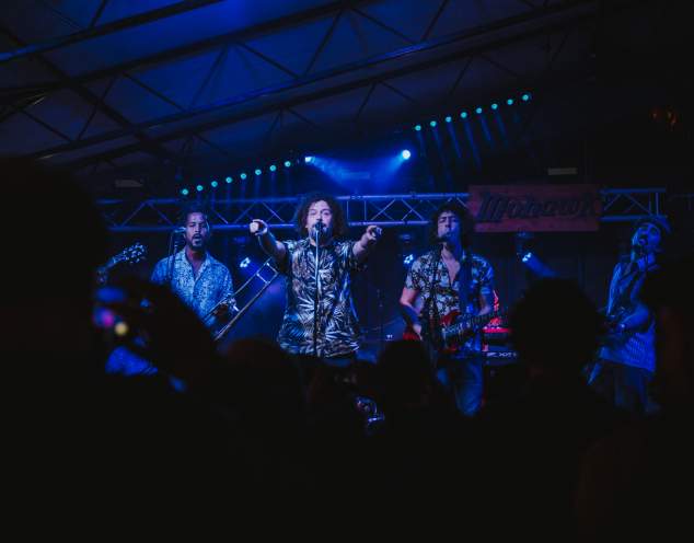 Superfonicos on stage at the Mohawk lead singer points out towards the crowd