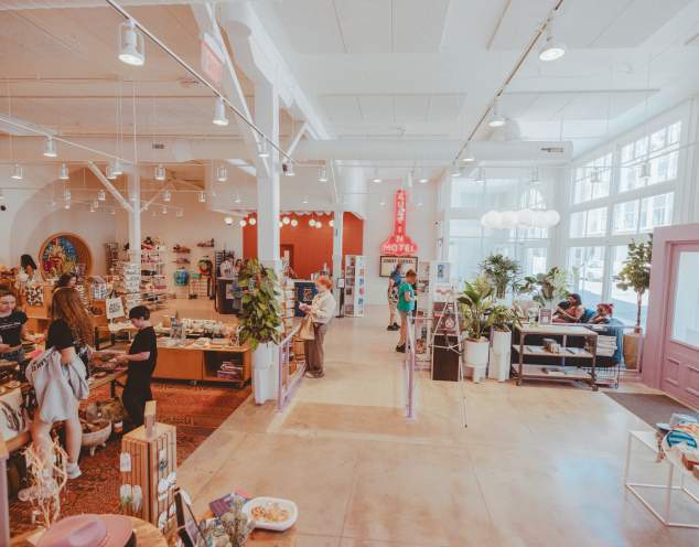 Austin Visitor Center shopping floor filled with colorful displays of merchandise and visitors browsing.