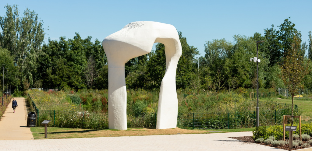 Henry Moore’s The Arch sculpture, life sized replica, located on the grounds of the gardens at the rear of Waltham Forest Town Hall, Walthamstow, E17. Town Hall buildings, clock tower and other sculptures to the walls can be seen.