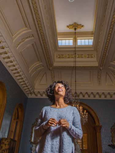A woman looks at the details on the ceiling inside of the Hay House in Macon, GA
