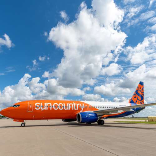 Sun Country Airlines aircraft parked on a runway at an airport