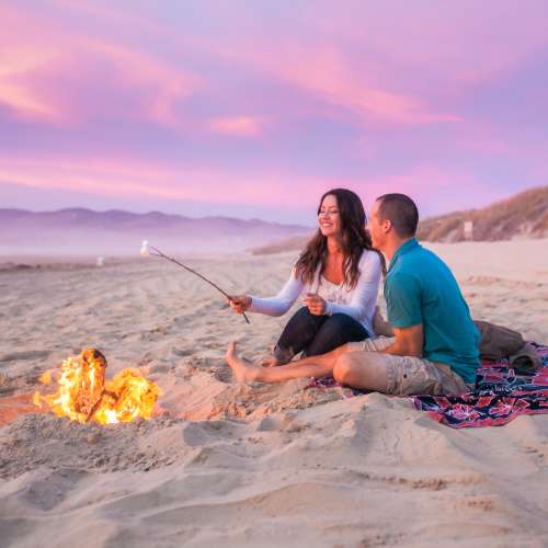 couple enjoying a bonfire on Grover Beach