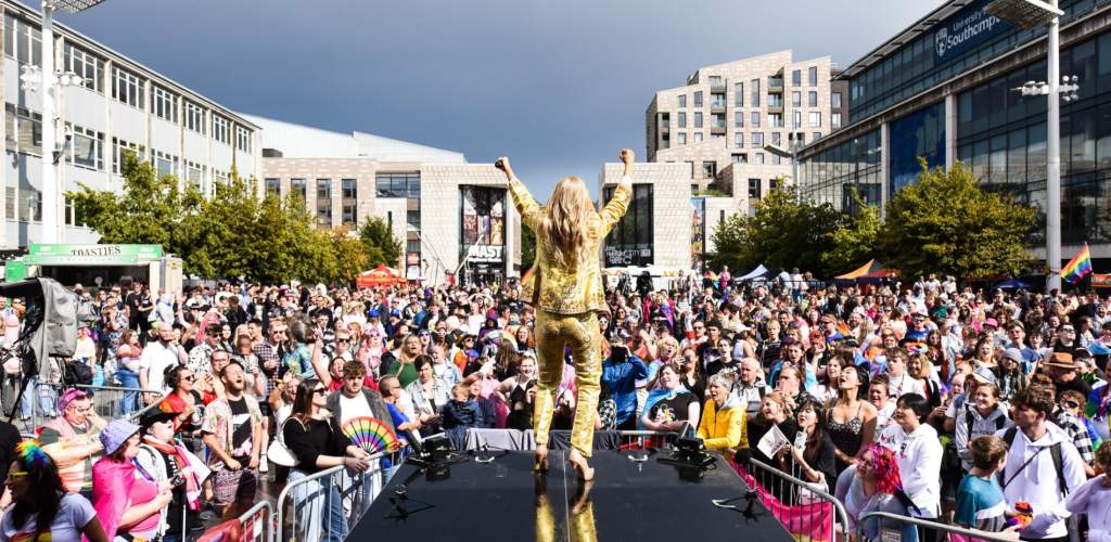 Southampton Pride mainstage with person in a gold suit and crowd