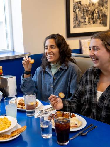 Three young women sitting at a table and enjoying their brunch at Monty's Blue Plate Diner.