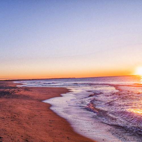 Golden sunset over the ocean at a sandy beach