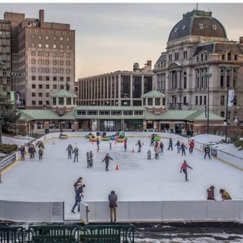 People ice skating at the Providence Rink on a winter day.