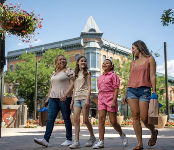 A family does summer shopping at Old Town Square with Linden in the background