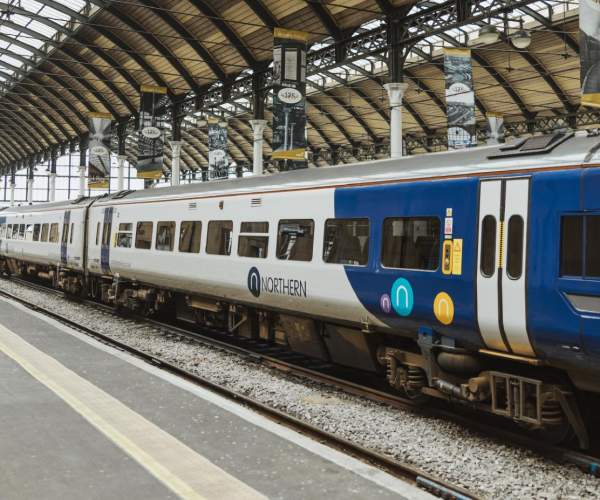 A Northern Rail train waiting at Hull Paragon Interchange under the station’s large arched roof, ready for passengers boarding