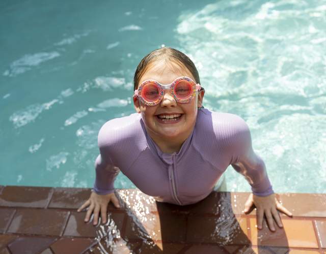 girl in goggles coming out of pool at Inn on Maritime Bay