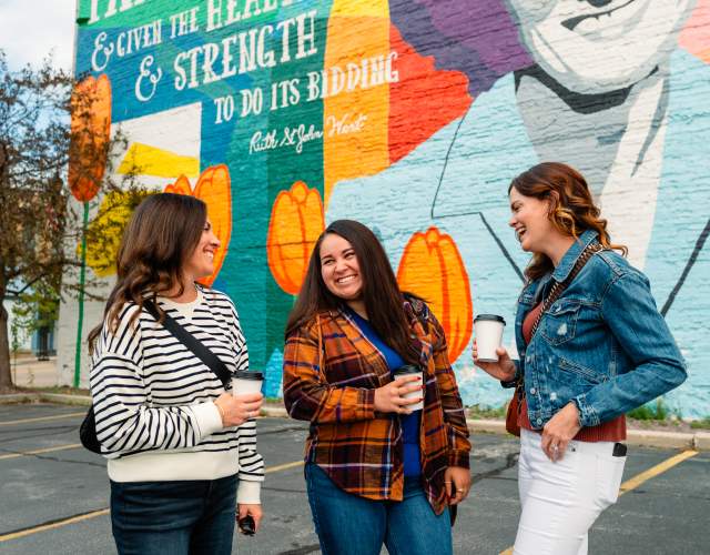 women in front of Ruth West mural in downtown Manitowoc Wisconsin