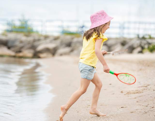 Girl Playing at Lighthouse Park Beach in Manitowoc