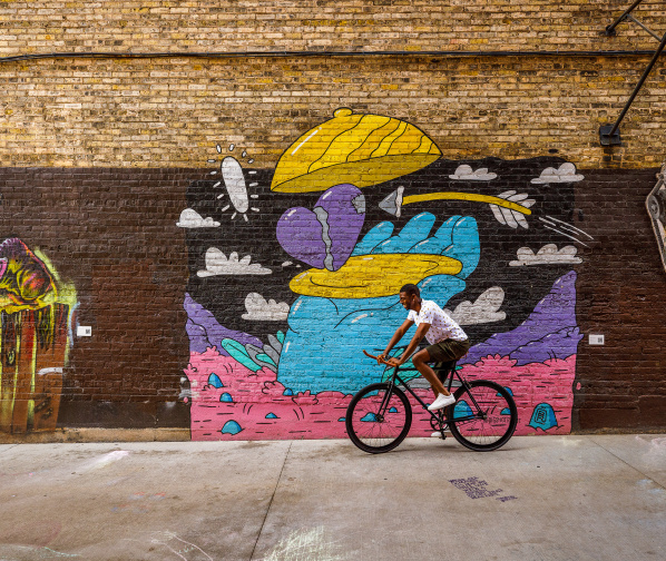 man biking through Black Cat Alley