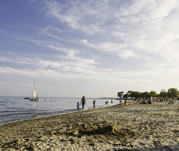 wide view of Bradford Beach, boats and people in the water