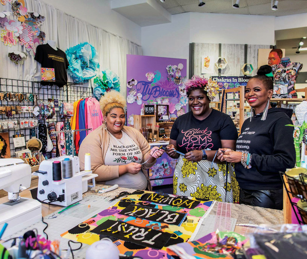 three women smiling in a store