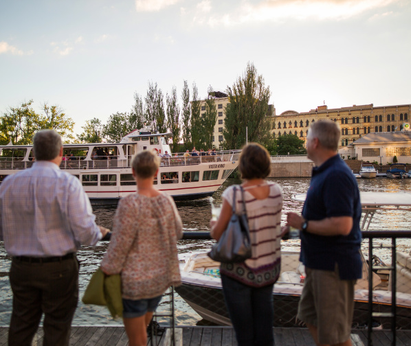 people looking at the VistaKing ship on the river in the Third Ward