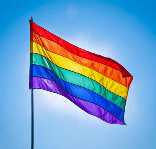 Gay flag with a clear sky background