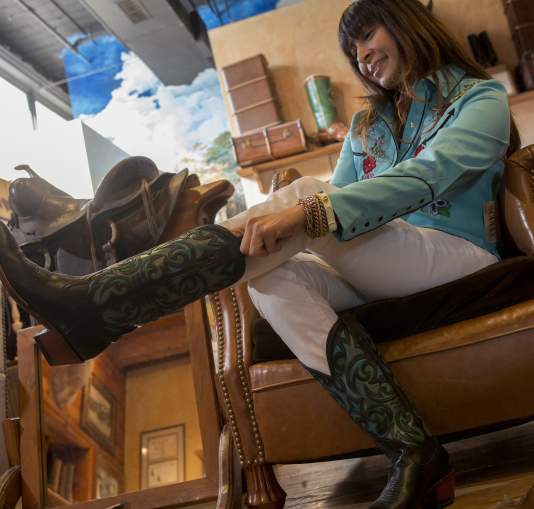Woman trying on a pair of cowboy boots