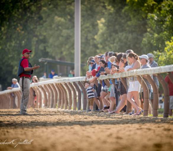 people standing on railing at Oklahoma Training Track