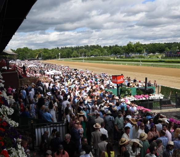 crowd watching horse racing at saratoga race course