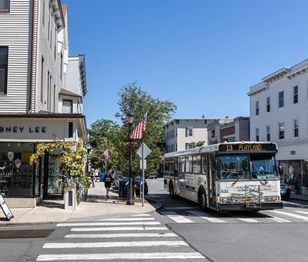 A Bee-Line Bus pass through the town of Rye where the streets are lined with shops and restaurants.