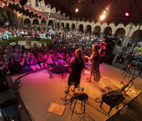 Musicians play on a stage at night in front of a crowd in Caramoor's Venetian Theater.