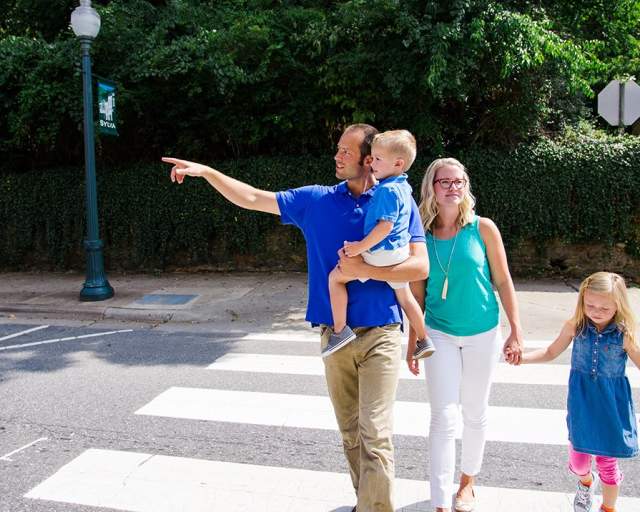 family crossing the street